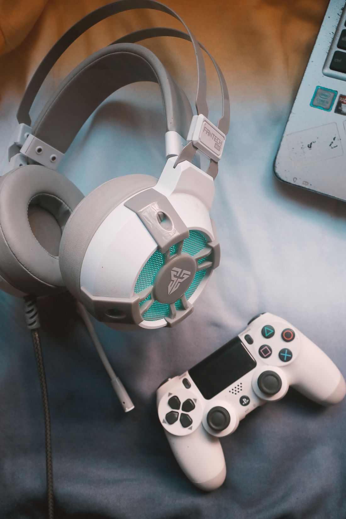 Gaming headphones and a game controller on a desk.